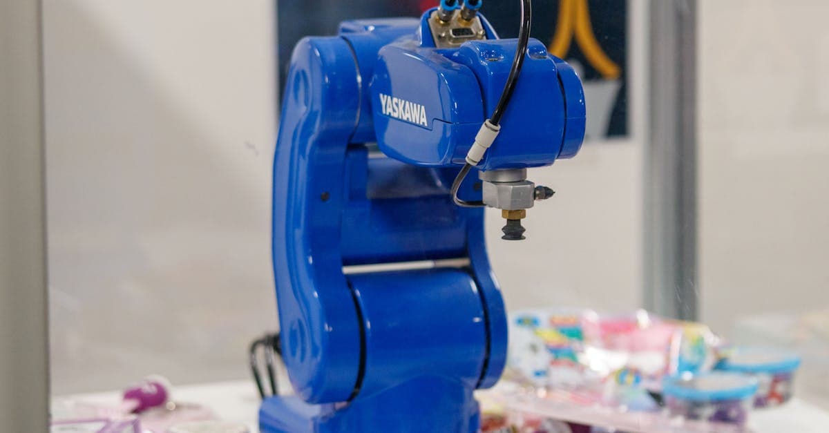 Industrial IoT sensors connected to CNC machines on a manufacturing shop floor with real-time data displays