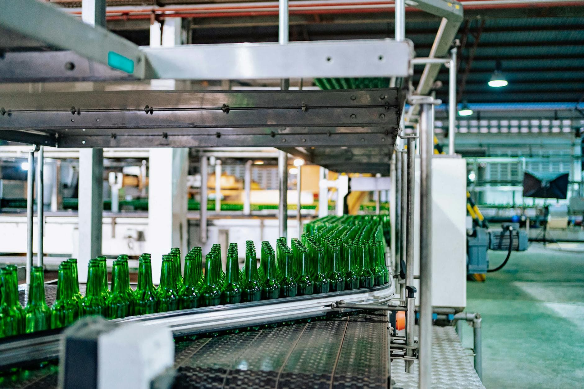 Factory floor with overhead cost allocation visible on a scheduling board showing machine hours and labor distribution