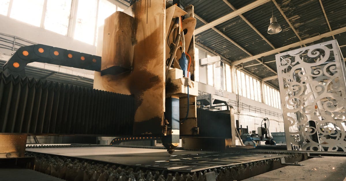 Metal fabrication shop floor with laser cutting, bending, and welding stations processing steel components