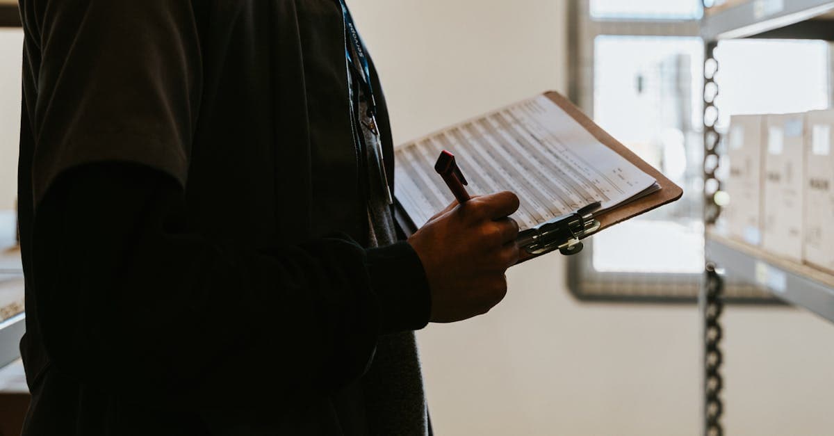 Project manager reviewing MRP implementation checklist with manufacturing team