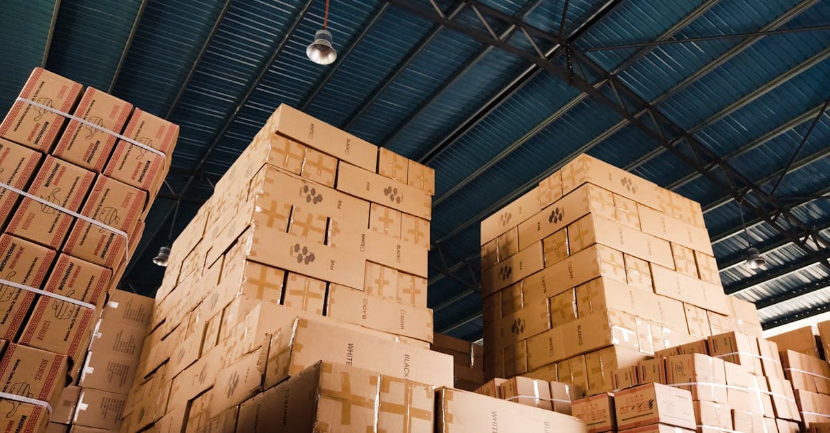Organized raw material storage area in a manufacturing facility with labeled bins and digital tracking system