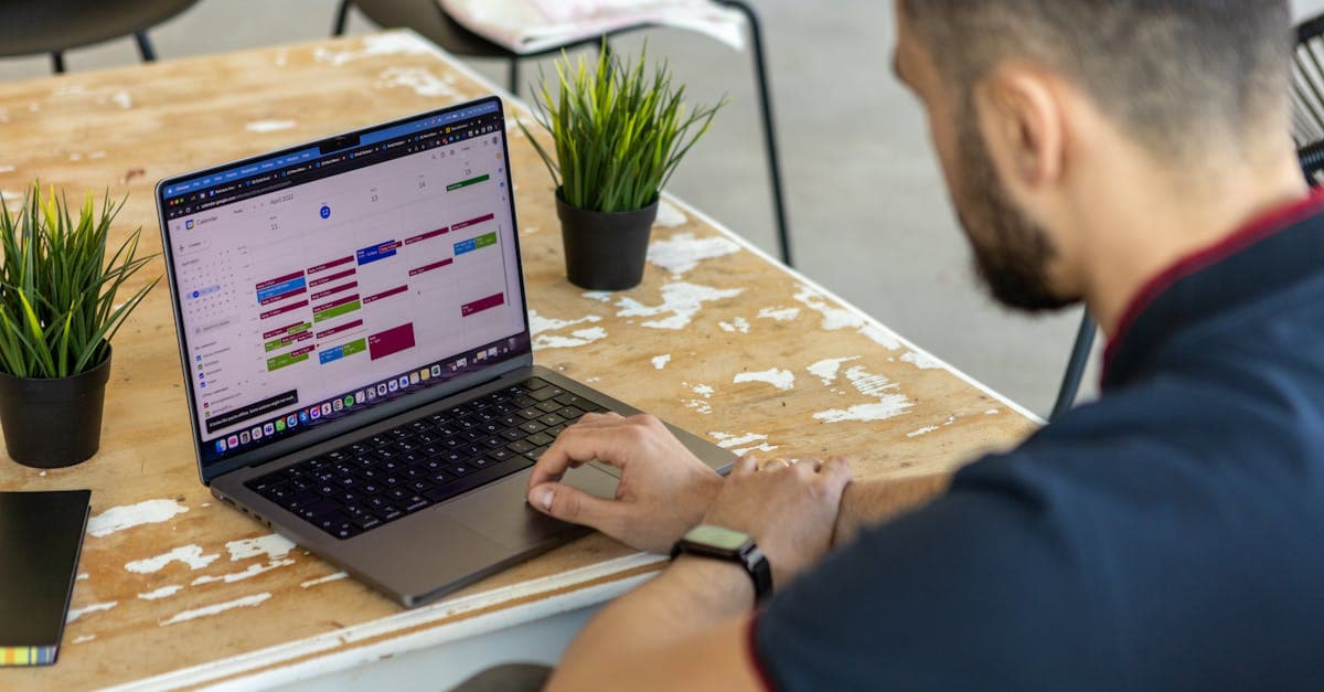 Implementation team reviewing production scheduling software setup on a large monitor during a planning session