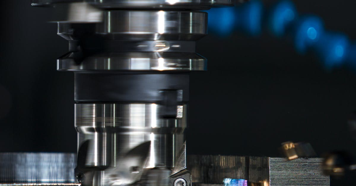 Small job shop floor with scheduling software displayed on a monitor next to CNC machines