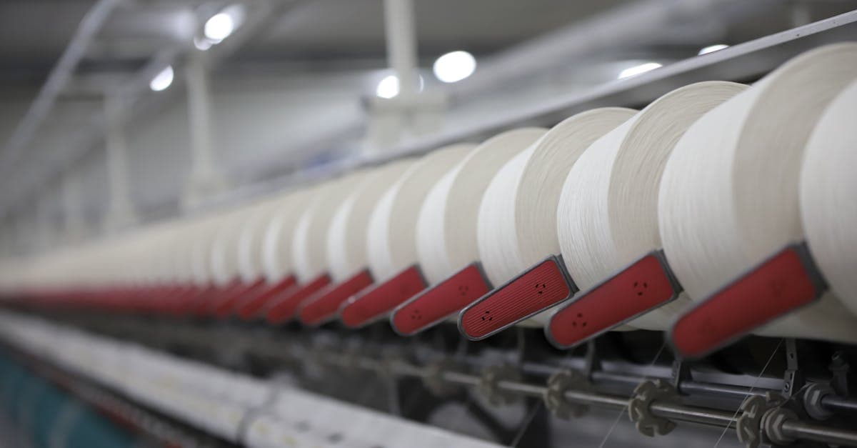 Textile manufacturing floor with cutting tables and sewing stations for garment production