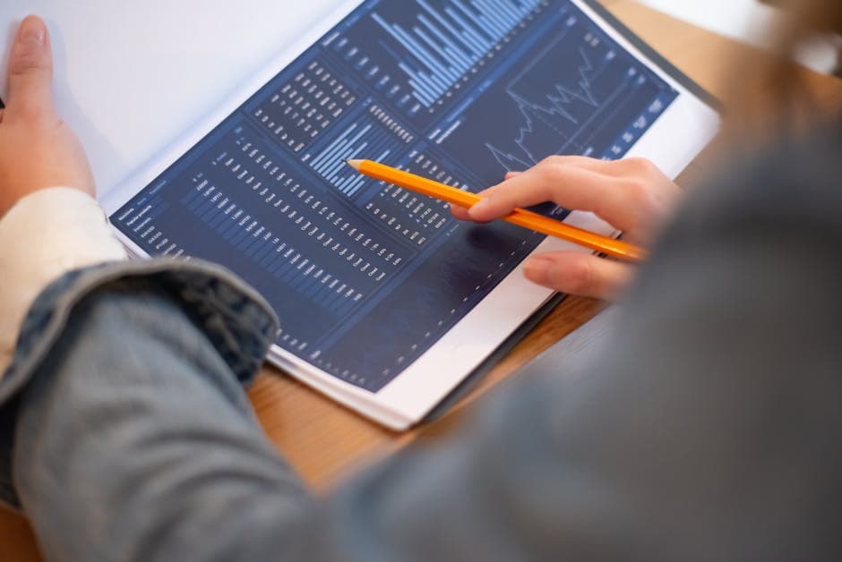 Data analyst reviewing manufacturing performance dashboards with analytics charts