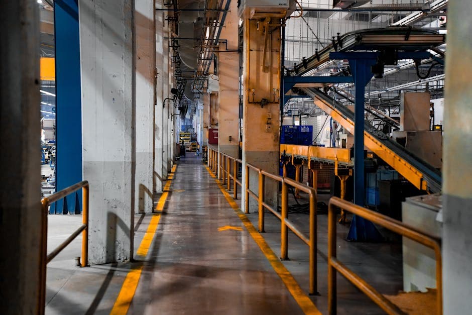 Industrial factory interior with conveyor system showing production flow and work-in-process