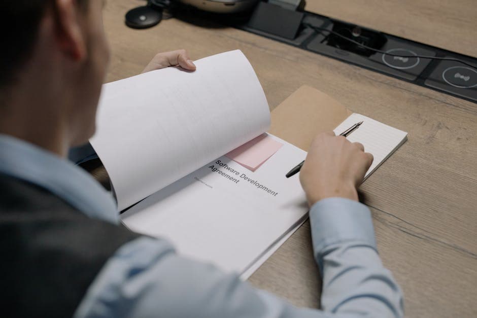 Business professional reviewing a software vendor contract at a desk