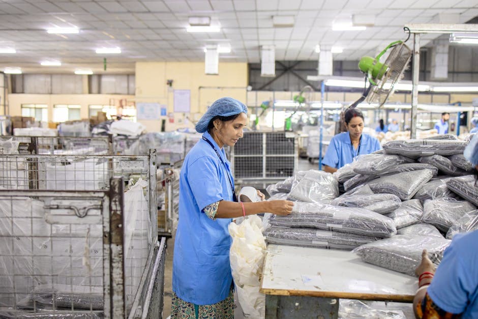 Manufacturing workers in a supplier factory sorting materials and components for production